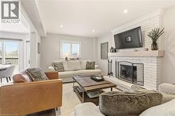 Living area with a fireplace and recessed lighting -