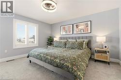 Bedroom featuring baseboards and light colored carpet -