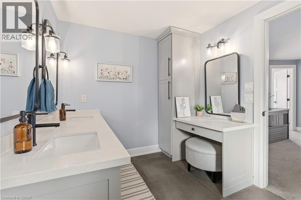 Bathroom featuring double vanity and dark tile patterned flooring - 697 Lambshead Drive, Burlington, ON - Indoor