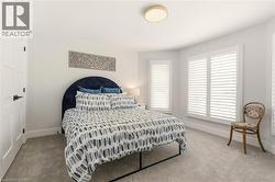 Carpeted bedroom with baseboards -