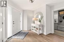 Foyer with light wood-style flooring and baseboards -