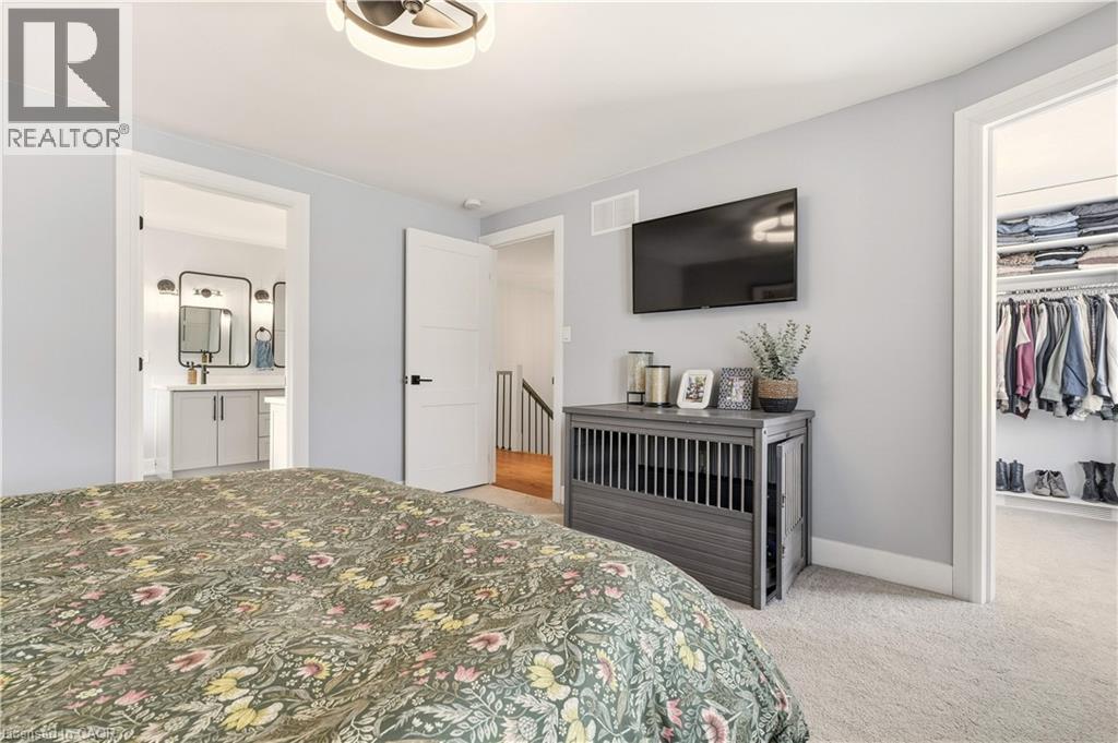 Bedroom with light colored carpet, a spacious closet, and ensuite bathroom - 697 Lambshead Drive, Burlington, ON - Indoor Photo Showing Bedroom