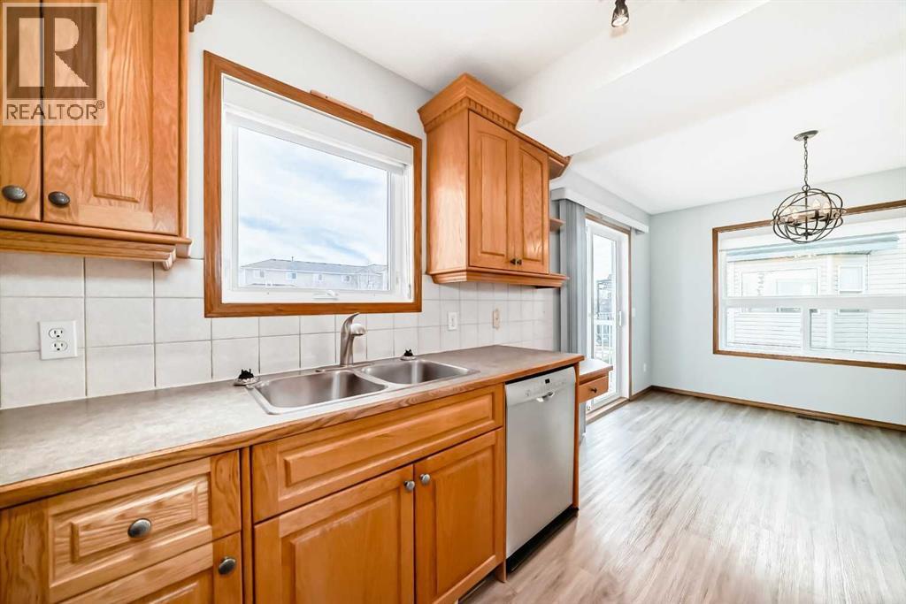 Kitchen is convenient to the dining area - 21 Hillview Road, Strathmore, AB - Indoor Photo Showing Kitchen With Double Sink