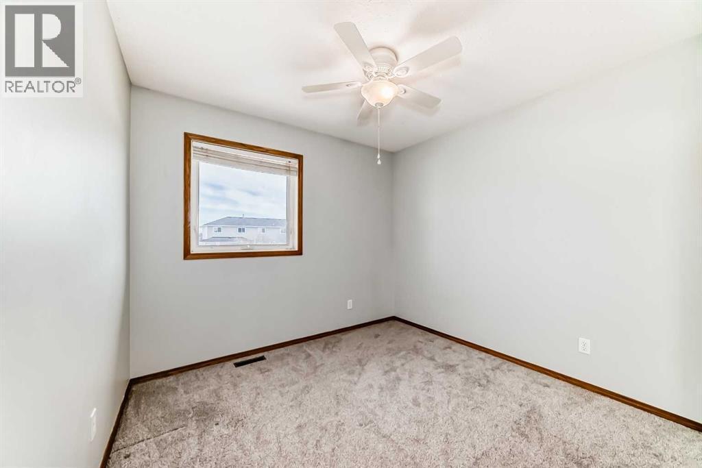 Bedroom 2 with big window - 21 Hillview Road, Strathmore, AB - Indoor Photo Showing Other Room