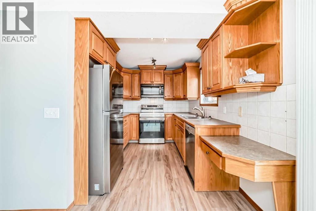 Full sized pantry is located on outer kitchen wall. Plenty of cupboard and counter space for all your culinary requirements - 21 Hillview Road, Strathmore, AB - Indoor Photo Showing Kitchen With Double Sink