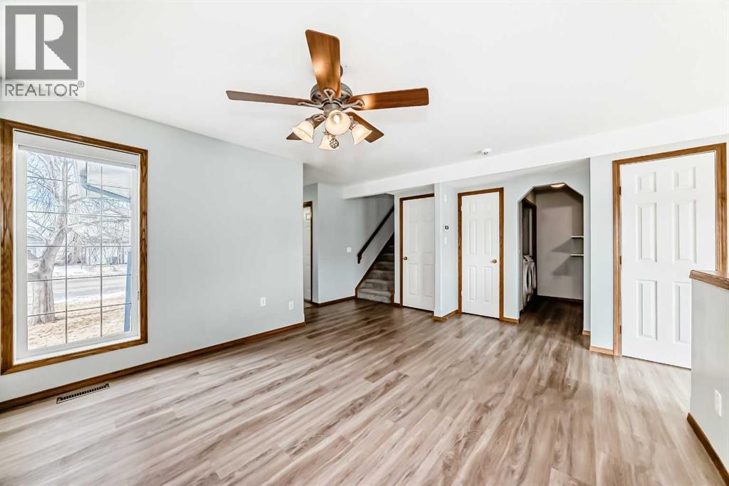 Off living room are the stairs to upper level, laundry room and half bath - 21 Hillview Road, Strathmore, AB - Indoor Photo Showing Other Room