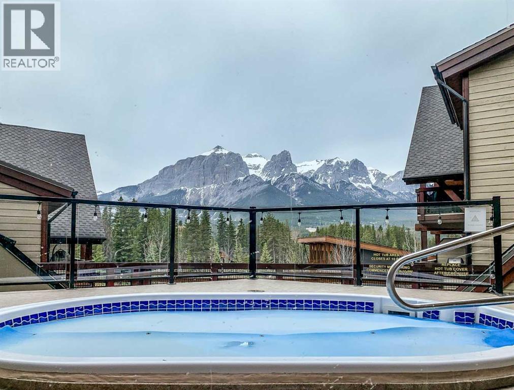 112, 379 Spring Creek Drive, Canmore, AB - Outdoor With Above Ground Pool With View