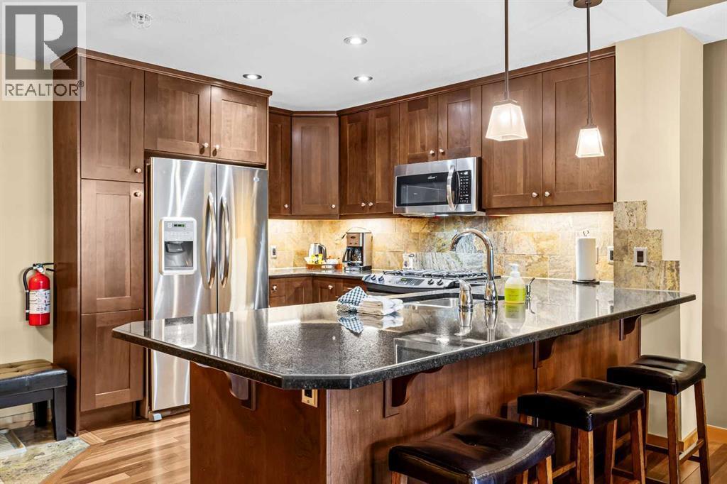 112, 379 Spring Creek Drive, Canmore, AB - Indoor Photo Showing Kitchen With Upgraded Kitchen