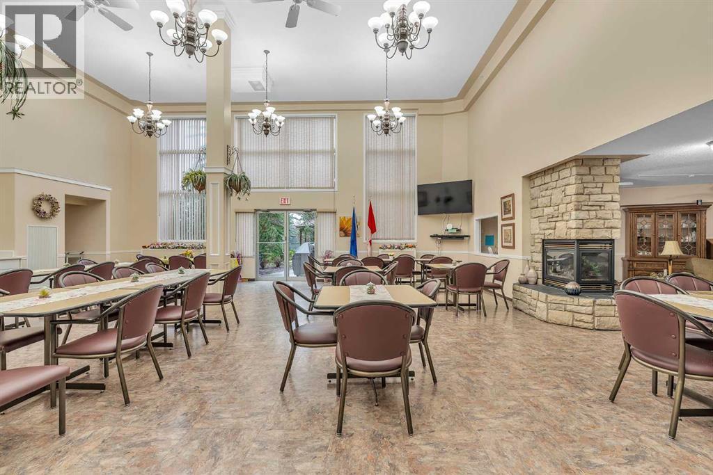 3340, 6818 Pinecliff Grove Ne, Calgary, AB - Indoor Photo Showing Dining Room With Fireplace