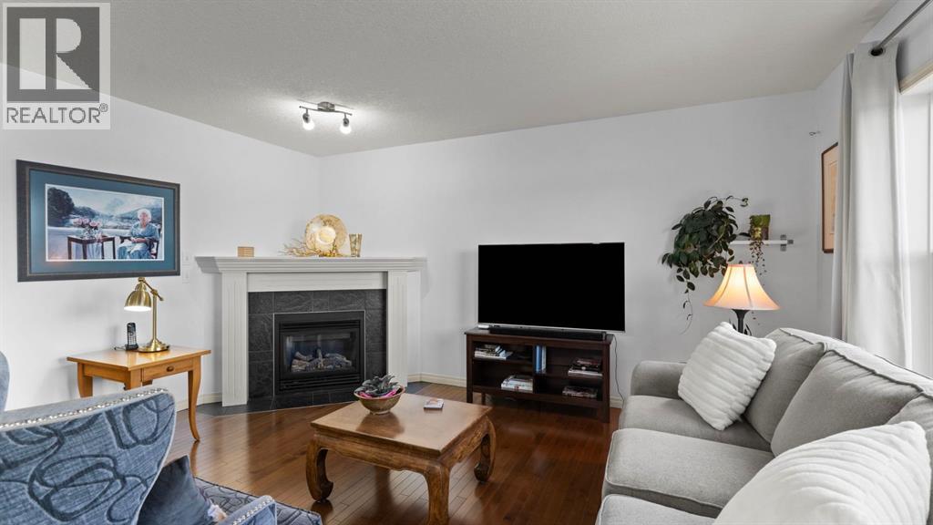 166 Bridlecrest Boulevard Sw, Calgary, AB - Indoor Photo Showing Living Room With Fireplace