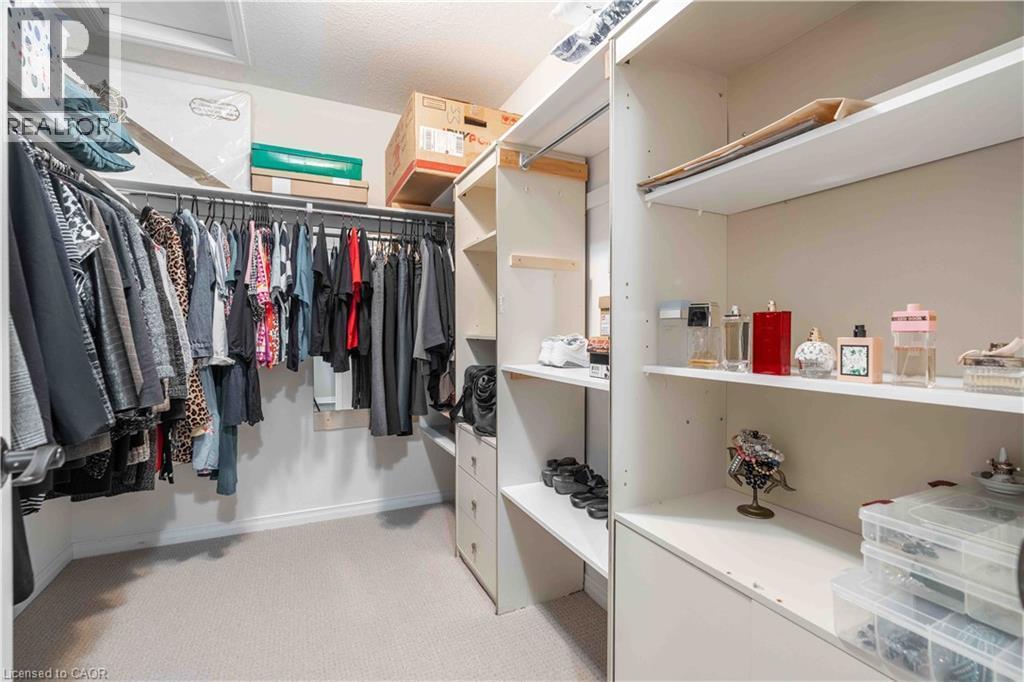 Walk in closet featuring lots of shelving and organizing opportunities, light carpet - 115 Larry Crescent, Caledonia, ON - Indoor With Storage