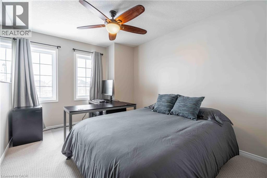 Bedroom with brand new light carpet, ceiling fan, and large windows for the best view! - 115 Larry Crescent, Caledonia, ON - Indoor Photo Showing Bedroom