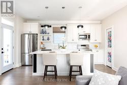 The large island can accommodate four stools. -