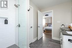 It features a stylish walk-in shower. -