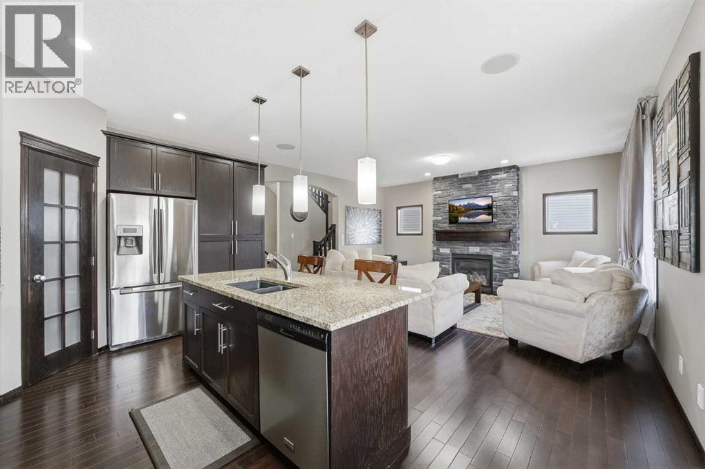 65 Elgin Meadows Circle Se, Calgary, AB - Indoor Photo Showing Kitchen With Fireplace With Stainless Steel Kitchen With Double Sink With Upgraded Kitchen