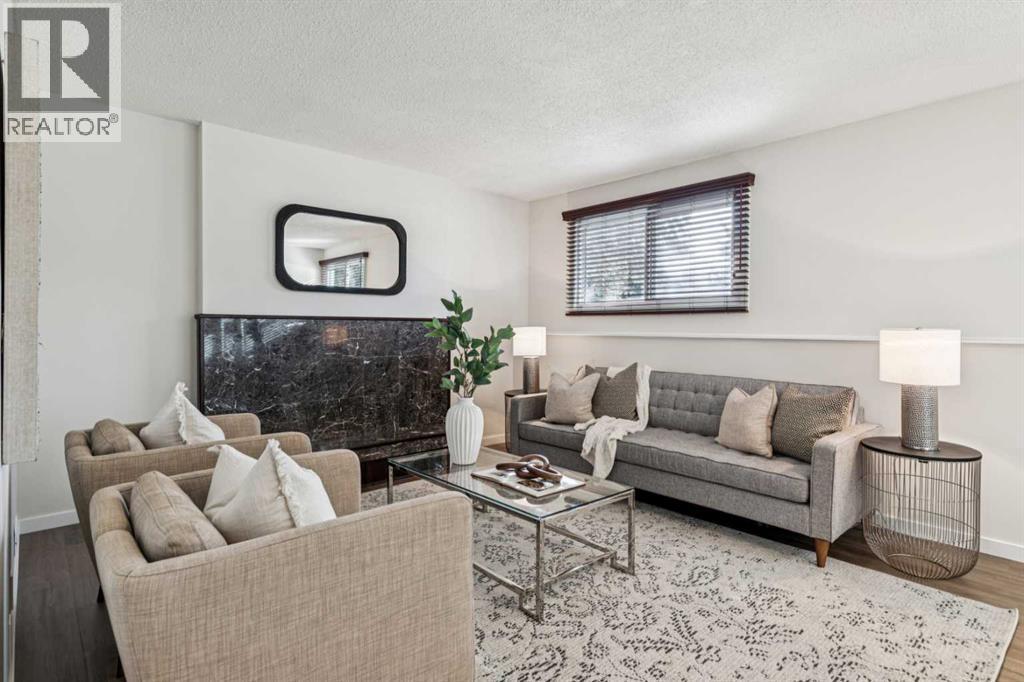 195 Lake Adams Crescent Se, Calgary, AB - Indoor Photo Showing Living Room With Fireplace