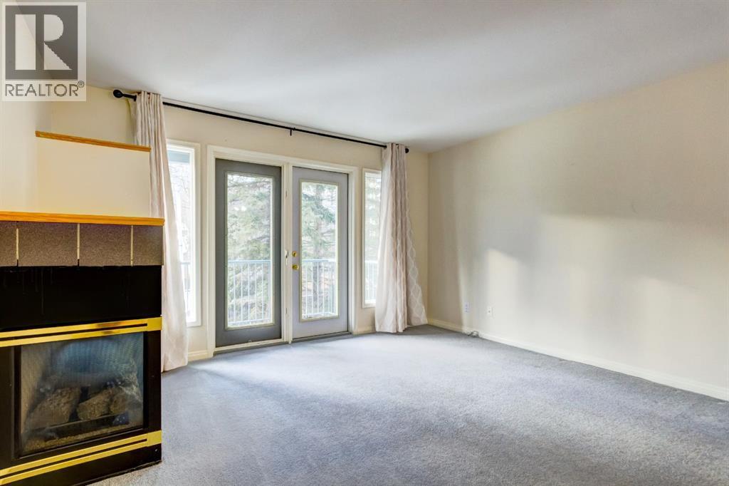 4, 704 8Th Avenue, Canmore, AB - Indoor Photo Showing Other Room With Fireplace