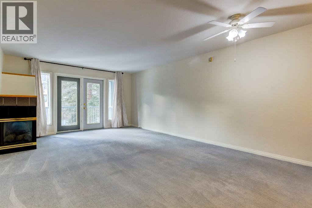 4, 704 8Th Avenue, Canmore, AB - Indoor Photo Showing Other Room With Fireplace
