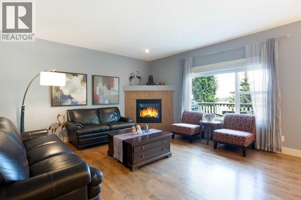 62 Panamount Road Nw, Calgary, AB - Indoor Photo Showing Living Room With Fireplace