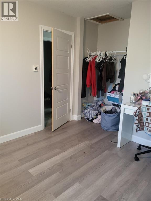 Bedroom with light wood-type flooring and ceiling fan - 18 Rosewell Street, Hamilton, ON - Indoor
