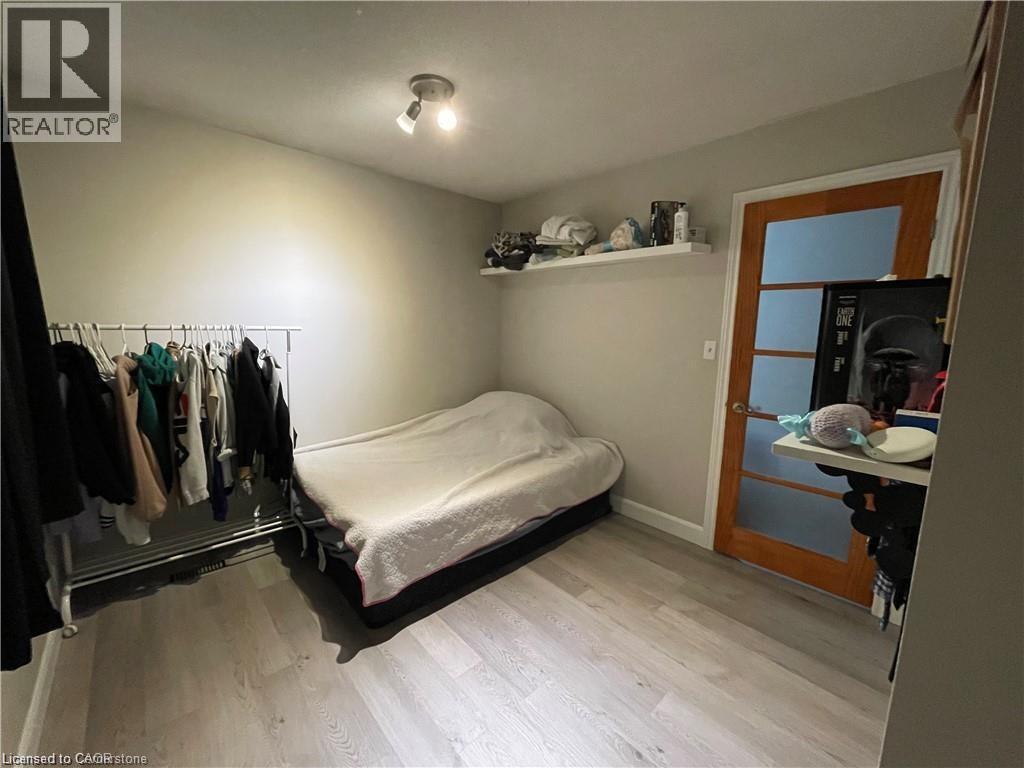 Bedroom featuring light wood-style floors and baseboards - 18 Rosewell Street, Hamilton, ON - Indoor Photo Showing Bedroom