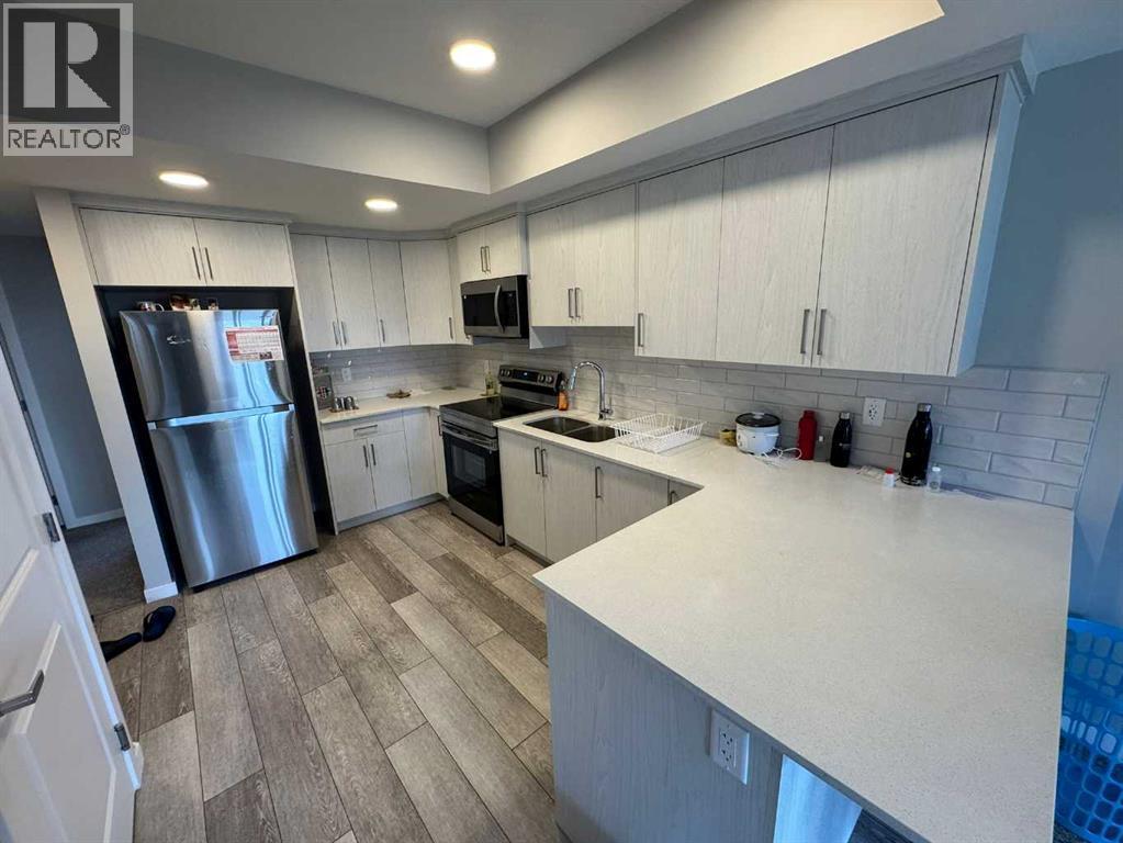 210 Lucas Close Nw, Calgary, AB - Indoor Photo Showing Kitchen With Stainless Steel Kitchen With Double Sink