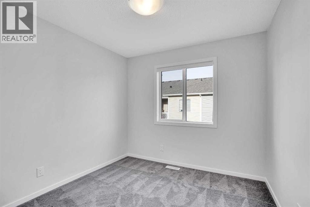 Bedroom 2 - 408 Windbury Link Sw, Airdrie, AB - Indoor Photo Showing Other Room