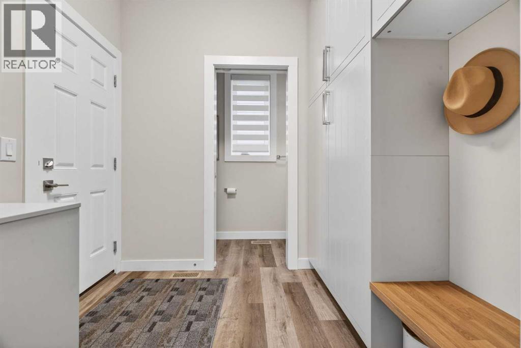 Mudroom off the garage with custom built-in cabinets and bench and storage - 307 Precedence Hill, Cochrane, AB - Indoor Photo Showing Other Room