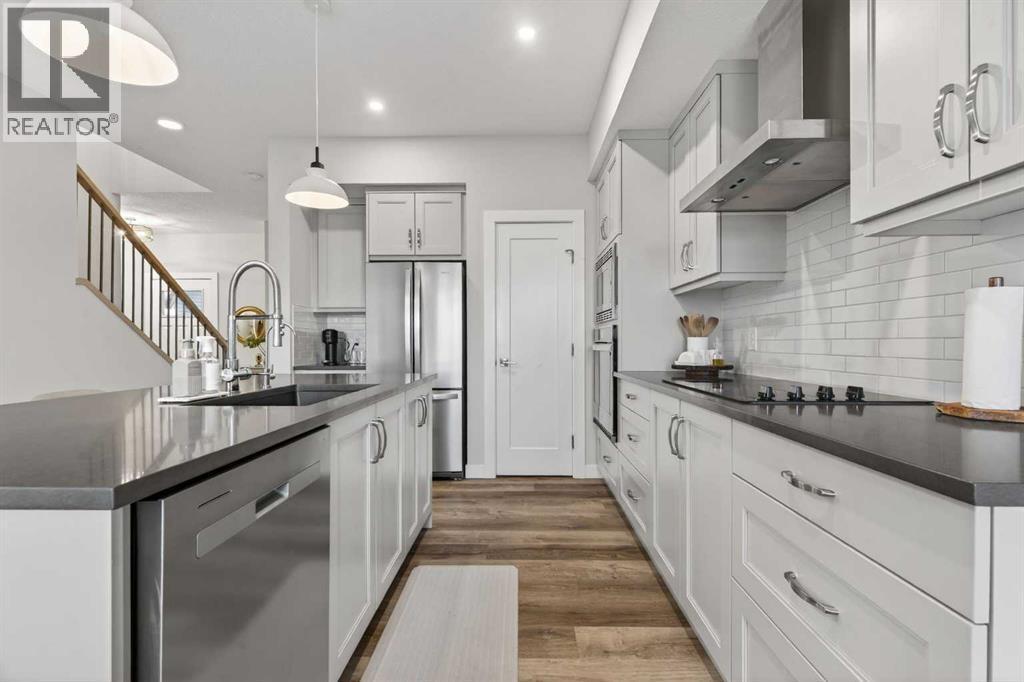 Neutral and warm chefs kitchen - 307 Precedence Hill, Cochrane, AB - Indoor Photo Showing Kitchen With Upgraded Kitchen