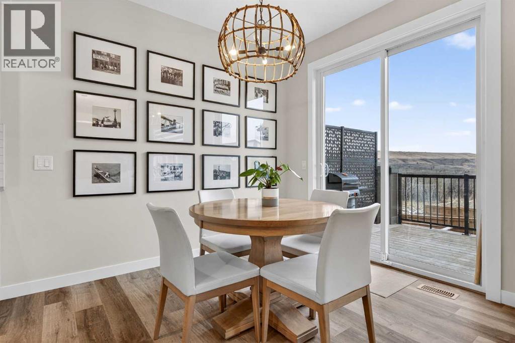 Dining room with direct access to the private back deck and yard - 307 Precedence Hill, Cochrane, AB - Indoor Photo Showing Dining Room