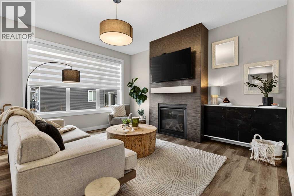 The perfect place to entertain or relax with your family - 307 Precedence Hill, Cochrane, AB - Indoor Photo Showing Living Room With Fireplace