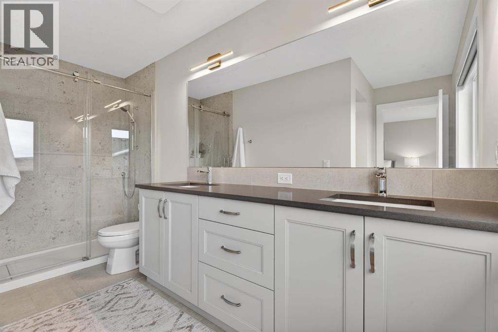 Newly updated chic ensuite with custom tiled shower with glass enclosure and double sinks - 307 Precedence Hill, Cochrane, AB - Indoor Photo Showing Bathroom