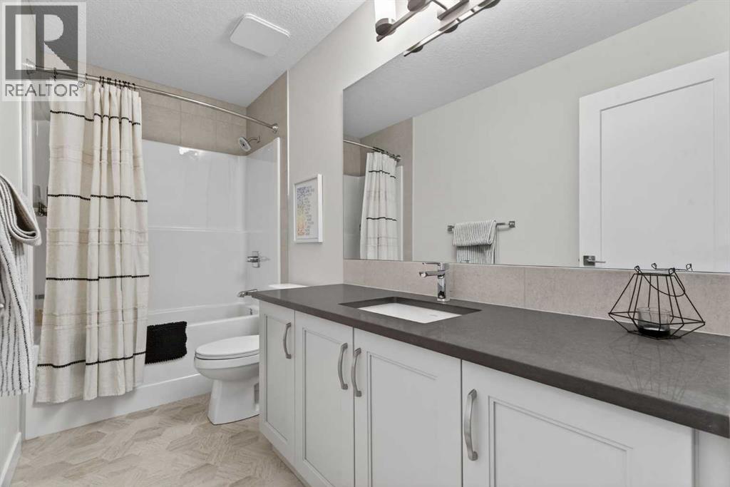 Second floor 4-piece bathroom with quartz countertops and ample storage - 307 Precedence Hill, Cochrane, AB - Indoor Photo Showing Bathroom