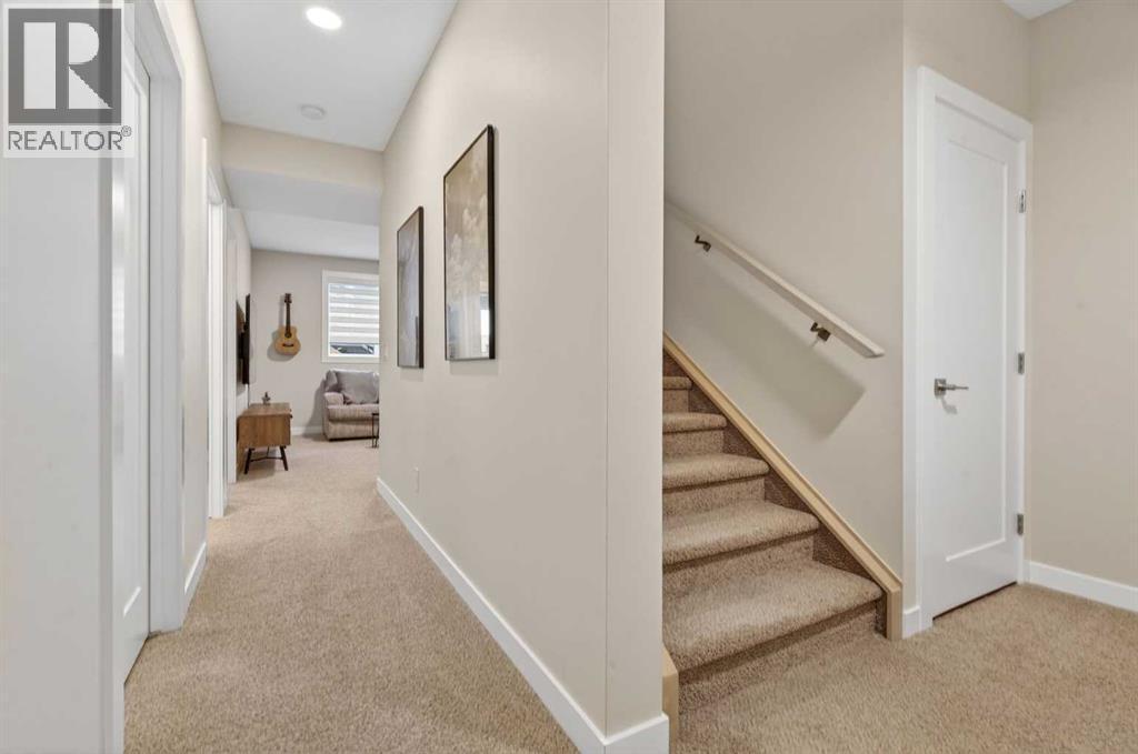 Basement hallway with access to main recreation room - 307 Precedence Hill, Cochrane, AB - Indoor Photo Showing Other Room