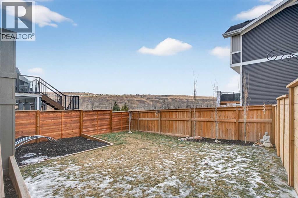 Fully landscaped backyard with fresh sod, new fence, and mulch gardens - 307 Precedence Hill, Cochrane, AB - Outdoor