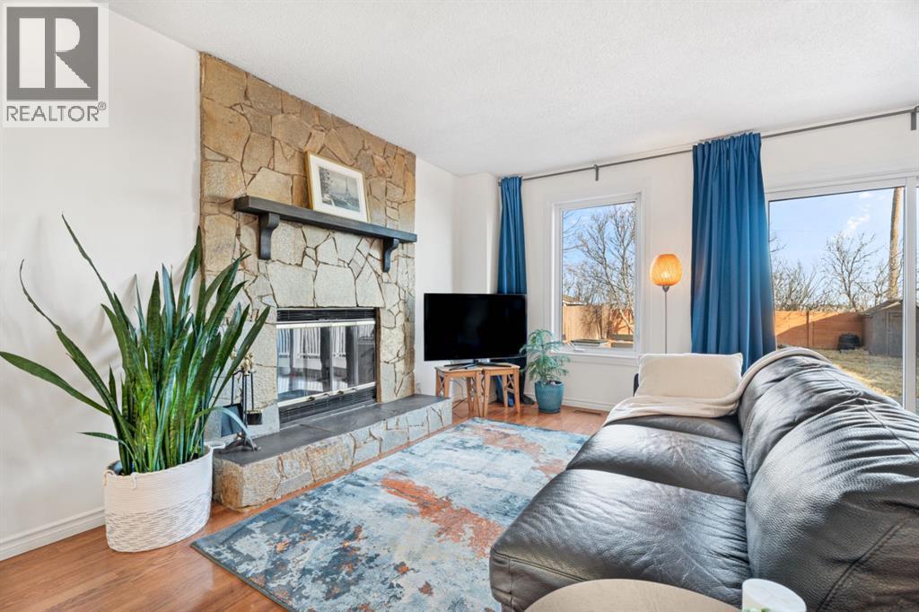 living room with wood burning fireplace - 164 Beddington Circle Ne, Calgary, AB - Indoor Photo Showing Living Room With Fireplace
