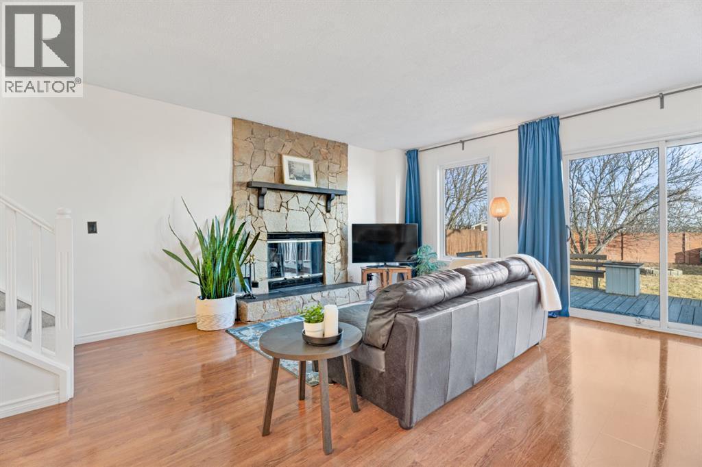 living room with wood burning fireplace - 164 Beddington Circle Ne, Calgary, AB - Indoor Photo Showing Living Room With Fireplace