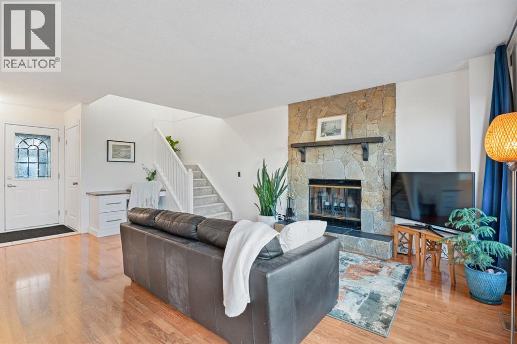 living room with wood burning fireplace - 164 Beddington Circle Ne, Calgary, AB - Indoor Photo Showing Living Room With Fireplace