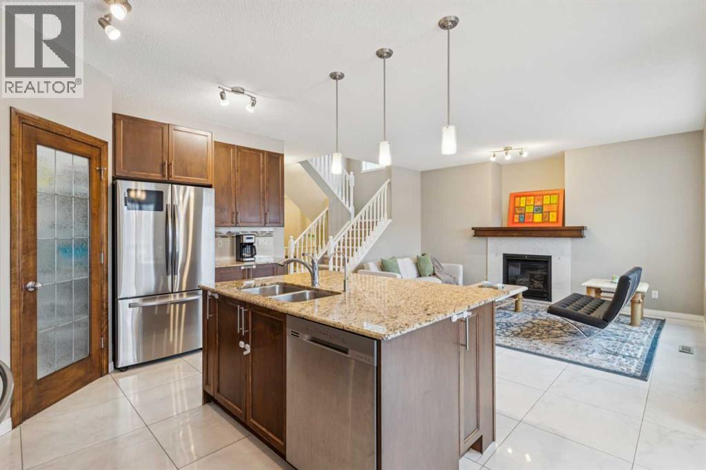 71 Walden Manor Se, Calgary, AB - Indoor Photo Showing Kitchen With Fireplace With Stainless Steel Kitchen With Double Sink