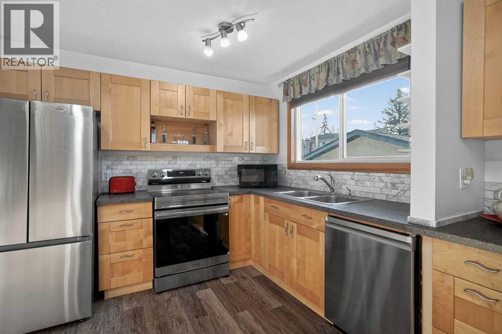 16 Rundleson Way Ne, Calgary, AB - Indoor Photo Showing Kitchen With Stainless Steel Kitchen With Double Sink