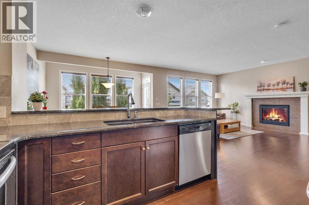 224 Panamount Point Nw, Calgary, AB - Indoor Photo Showing Kitchen With Fireplace