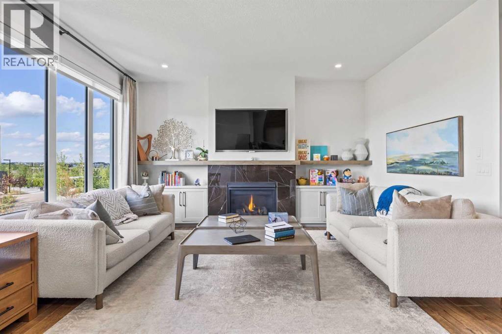 656 Bayview Way Sw, Airdrie, AB - Indoor Photo Showing Living Room With Fireplace