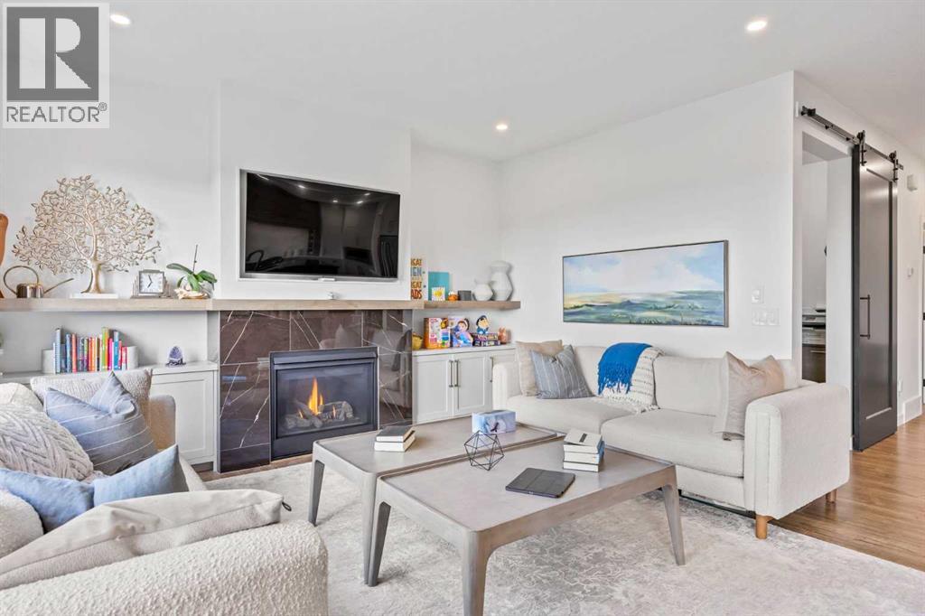 656 Bayview Way Sw, Airdrie, AB - Indoor Photo Showing Living Room With Fireplace