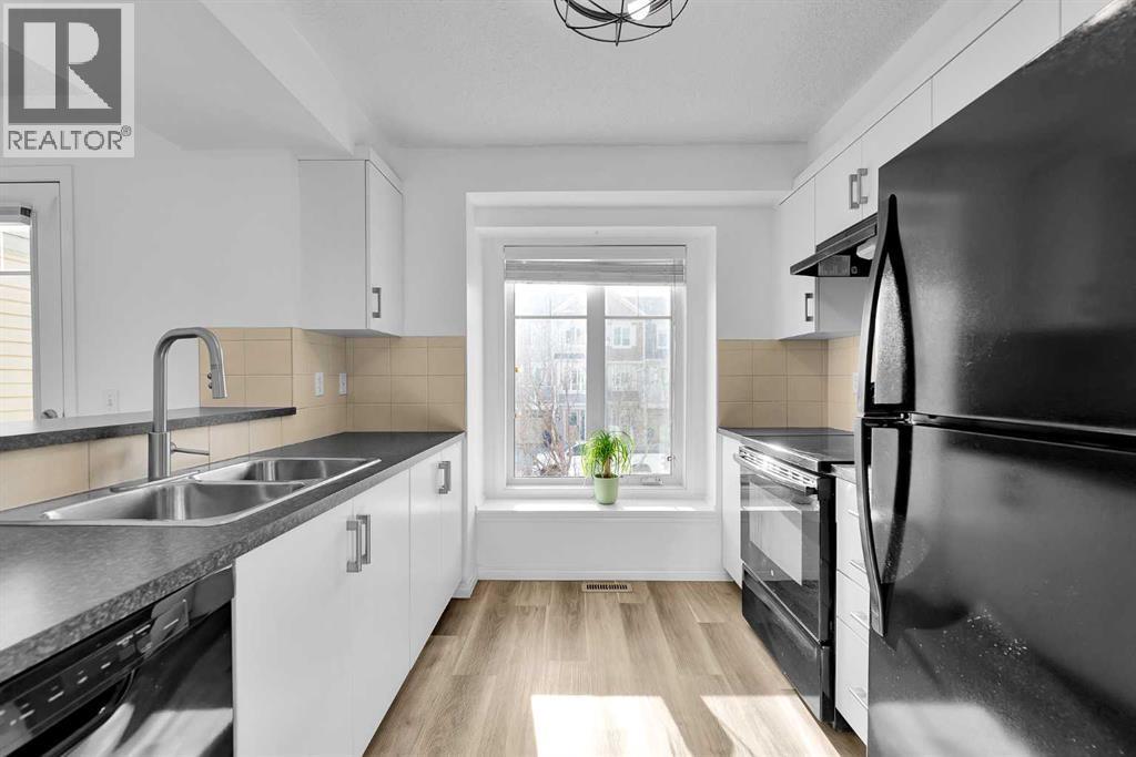 bright kitchen - 169 Windstone Park Sw, Airdrie, AB - Indoor Photo Showing Kitchen With Double Sink