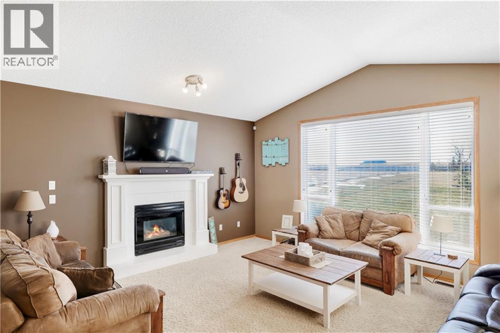 272210 Range Road 291 Ne, Airdrie, AB - Indoor Photo Showing Living Room With Fireplace