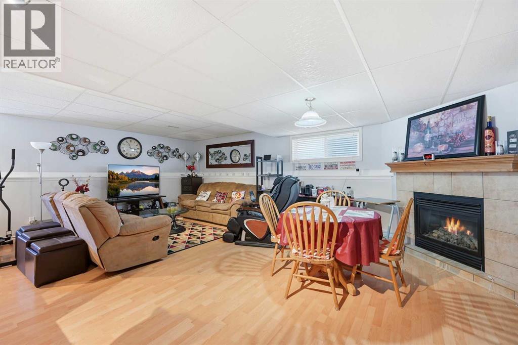 311 Saddlecreek Point Ne, Calgary, AB - Indoor Photo Showing Living Room With Fireplace