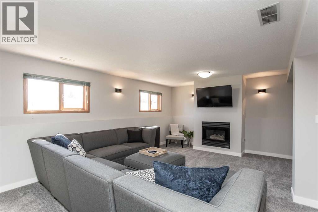 34 Bruns Bay, Lacombe, AB - Indoor Photo Showing Living Room With Fireplace
