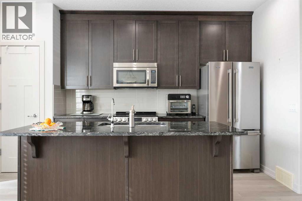 167 Fireside Drive, Cochrane, AB - Indoor Photo Showing Kitchen With Stainless Steel Kitchen With Upgraded Kitchen