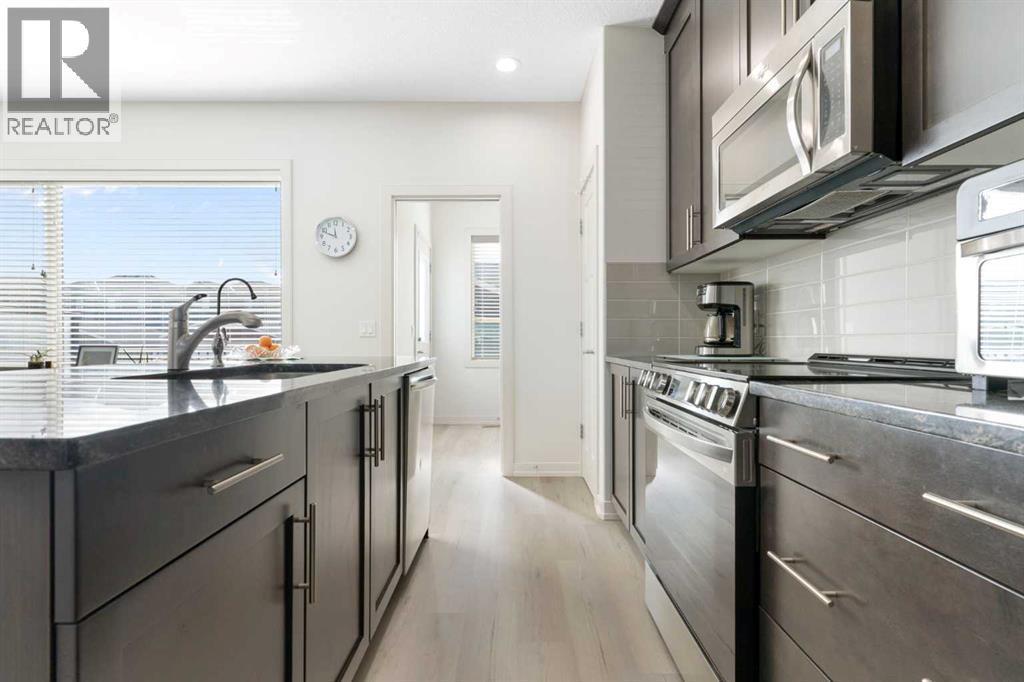 167 Fireside Drive, Cochrane, AB - Indoor Photo Showing Kitchen With Upgraded Kitchen