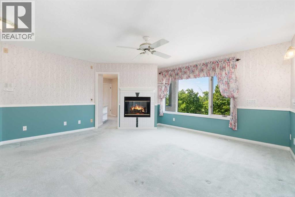 1600 Evergreen Hill Sw, Calgary, AB - Indoor Photo Showing Other Room With Fireplace